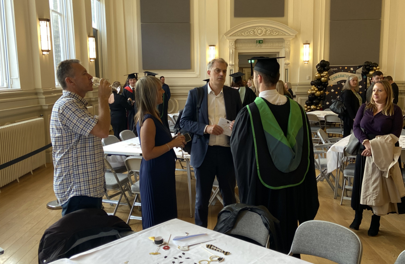 Julian speaking to student at Craven College graduation