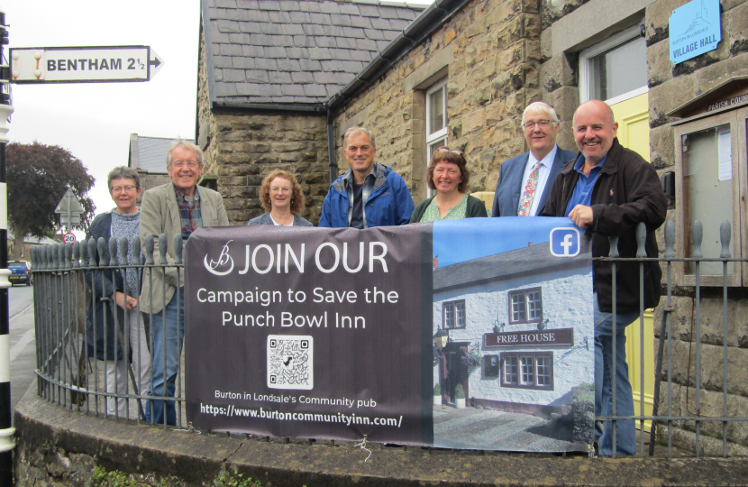 Julian and residents stood behind banner advertising the campaign