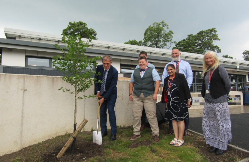 Julian plants a tree at Craven College 