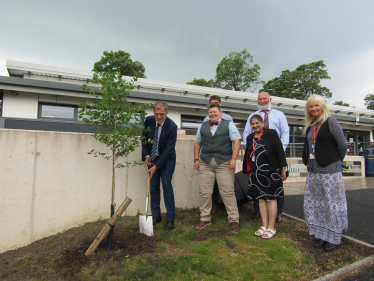 Julian plants a tree at Craven College 