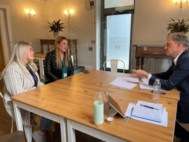 Julian Smith MP speaking with Tia-Joanne Fenton (left) and Kat Hawley (centre)